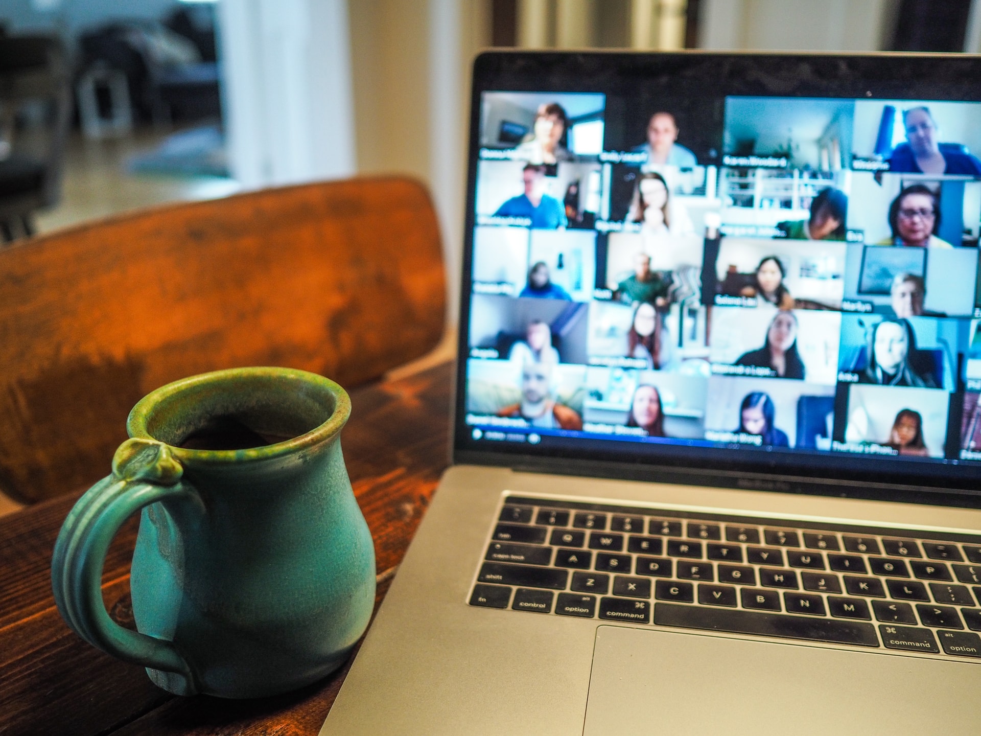 Laptop with a cup next to it